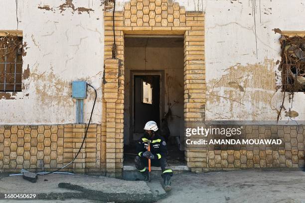 An Emirati emergency responder rests in a doorway in Libya's eastern city of Derna on September 19, 2023. Turkey, Egypt and the United Arab Emirates...