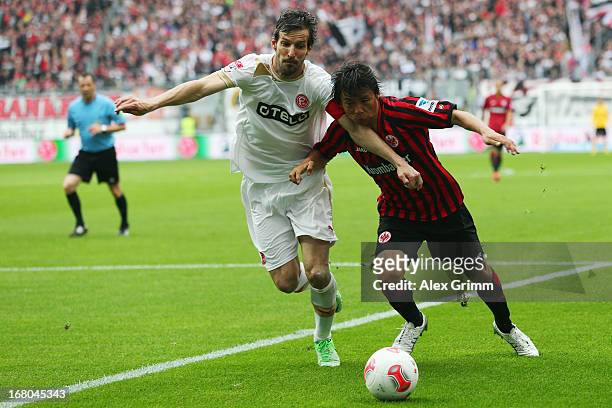 Takashi Inui of Frankfurt is challenged by Jens Langeneke of Duesseldorf during the Bundesliga match between Eintracht Frankfurt and Fortuna...
