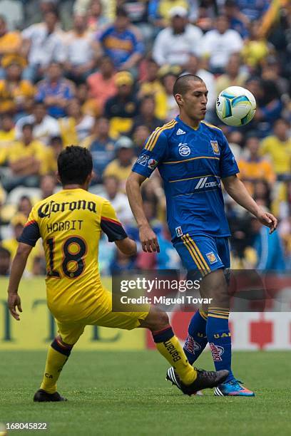Jose Torres of Tigres fights for the ball with Christian Bermudez of America during a match between America and Tigres as part of the Clausura 2013...