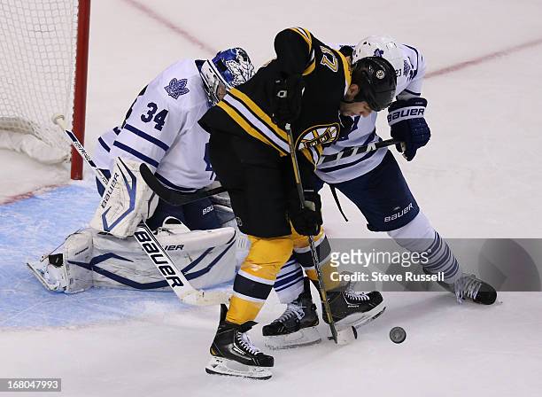 Toronto Maple Leafs defenseman Ryan O'Byrne ties up Milan Lucic in front of the net as the Toronto Maple Leafs play the Boston Bruins in Game 2 in...