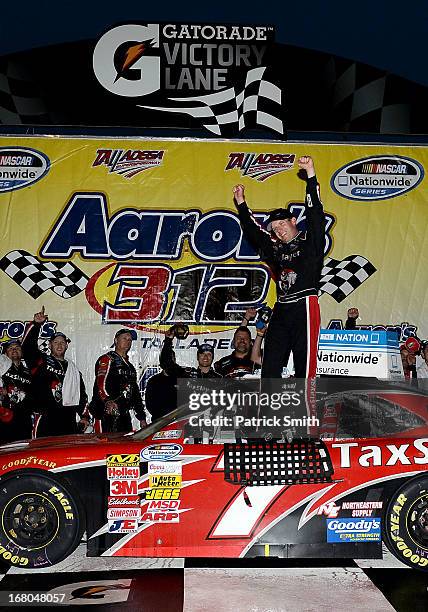 Regan Smith, driver of the TaxSlayer.com Chevrolet, celebrates with his crew in victory lane after he won the NASCAR Nationwide Series Aaron's 312 at...