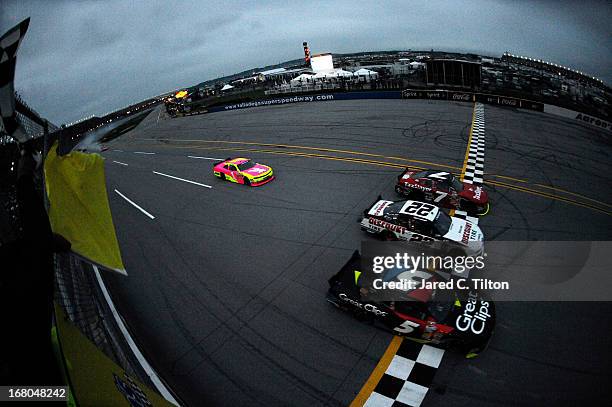 Regan Smith, driver of the TaxSlayer.com Chevrolet, crosses the finish first ahead of Kasey Kahne, driver of the Great Clips Chevrolet, and Joey...