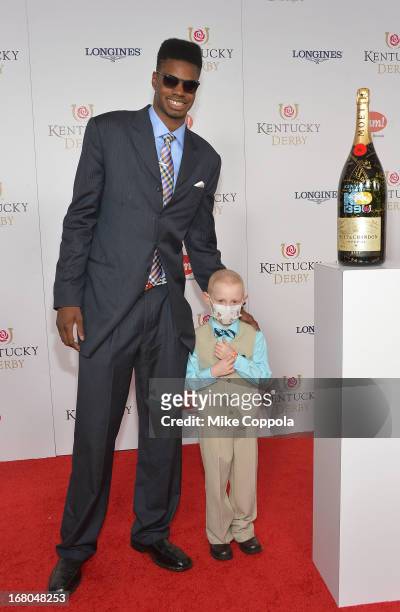 Athlete Nerlens Noel and Kelly Melton sign the Moet & Chandon 6L for the Churchill Downs Foundation during the 139th Kentucky Derby at Churchill...