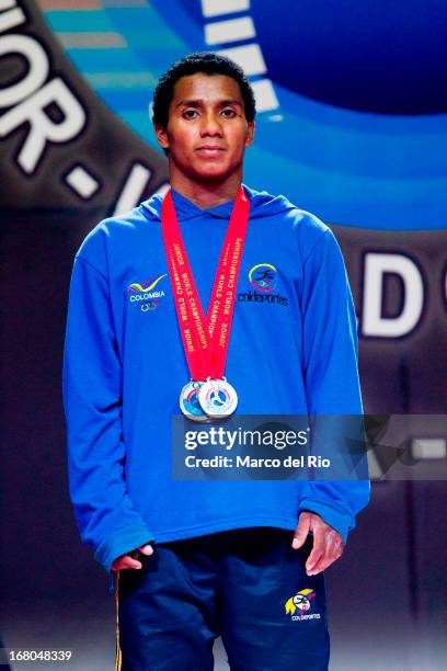 Colombian Mendoza poses with his medals of the Men's 56kg during day one of the 2013 Junior Weightlifting World Championship at Maria Angola...