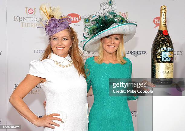 Taunya Eshenbaugh and Tonya York Dees sign the Moet & Chandon 6L for the Churchill Downs Foundation during the 139th Kentucky Derby at Churchill...