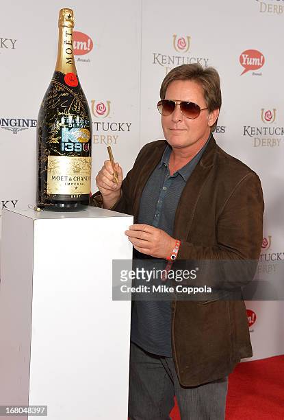 Actor Emilio Estevez signs the Moet & Chandon 6L for the Churchill Downs Foundation during the 139th Kentucky Derby at Churchill Downs on May 4, 2013...