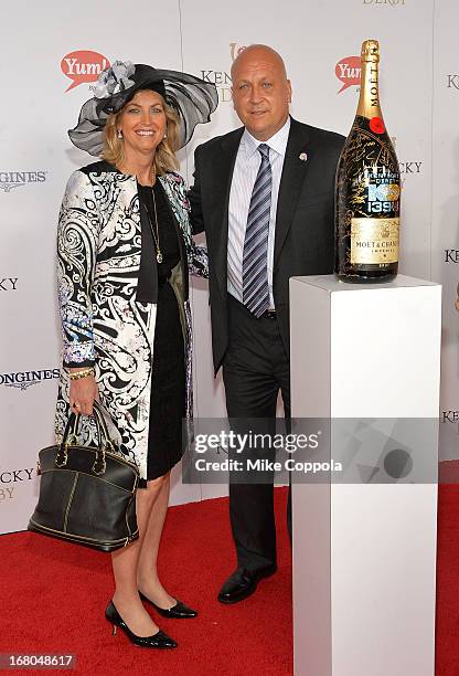 Athlete Cal Ripken, Jr. And wife Kelly Ripken sign the Moet & Chandon 6L for the Churchill Downs Foundation during the 139th Kentucky Derby at...