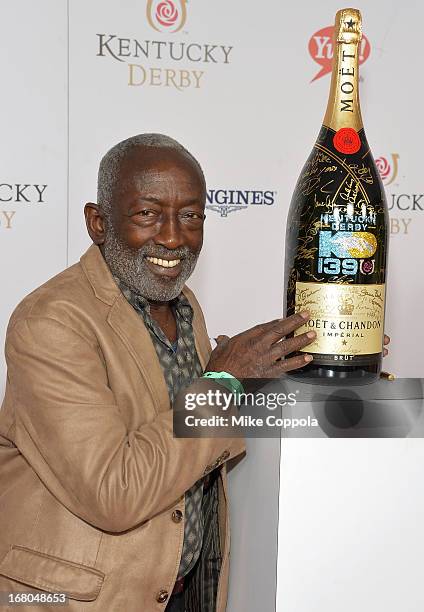 Garrett Morris signs the Moet & Chandon 6L for the Churchill Downs Foundation during the 139th Kentucky Derby at Churchill Downs on May 4, 2013 in...