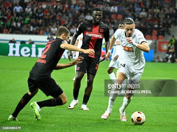 Bayer Leverkusen's Croatian defender Josip Stanisic and BK Hacken's Tunisian forward Amor Layouni vie for the ball during the UEFA Europa League...