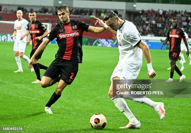 Bayer Leverkusen's Croatian defender Josip Stanisic and BK Hacken's Tunisian forward Amor Layouni vie for the ball during the UEFA Europa League...