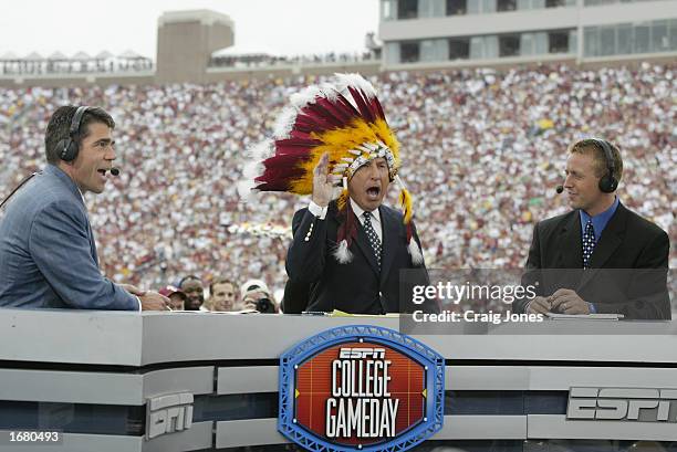 College GameDay announcer Lee Corso dons an FSU headress as co-announcers Chris Fowler and Kirk Herbstreit comment during the NCAA football game...
