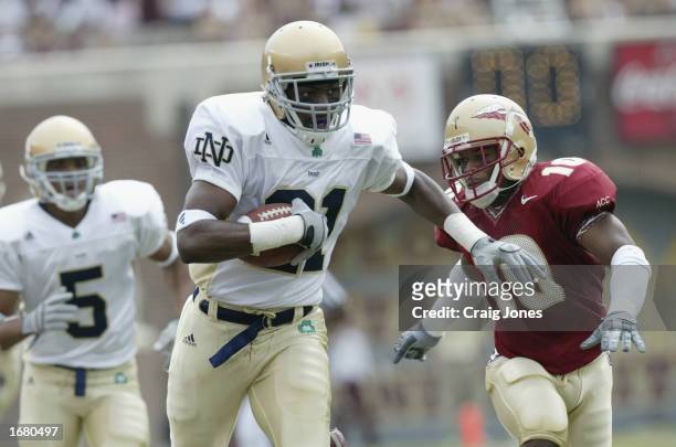 Notre Dame wide receiver Maurice Stovall runs the ball persued by FSU cornerback Stanford Samuels during the NCAA football game at Doak Campbell...