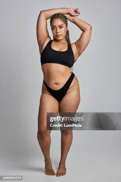 beauty, plus size and portrait of woman in studio for wellness, confidence and body positivity. spa, skincare and natural african person in underwear for pride, self love and glow on gray background - voluptuous black women stockfoto's en -beelden