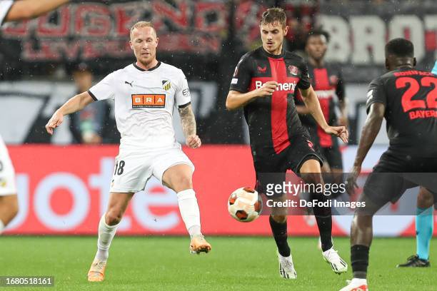 Mikkel Rygaard of BK Haecken and Josip Stanisic of Bayer 04 Leverkusen battle for the ball during the UEFA Europa League 2023/24 group stage match...