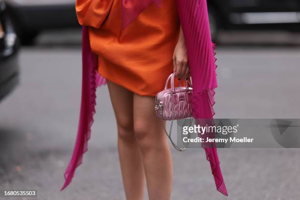 Oralia A. Villarreal Cantú was seen wearing a light pink Miu Miu bag, a black bra, a orange silk skirt, silver high heels and a transparent pink top...