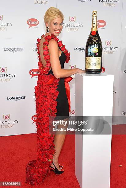 Shannon Voss wearing the 2013 Rose Dress designed by Amy Streeter signs the Moet & Chandon 6L for the Churchill Downs Foundation during the 139th...