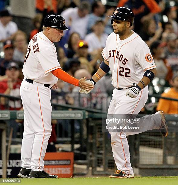 Carlos Corporan of the Houston Astros receives congratuations from Dave Trembley of the Houston Astros after hitting a home run in he seventh inning...