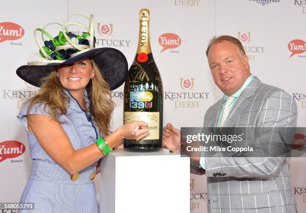 Coach Mark Stoops signs the Moet & Chandon 6L for the Churchill Downs Foundation during the 139th Kentucky Derby at Churchill Downs on May 4, 2013 in...