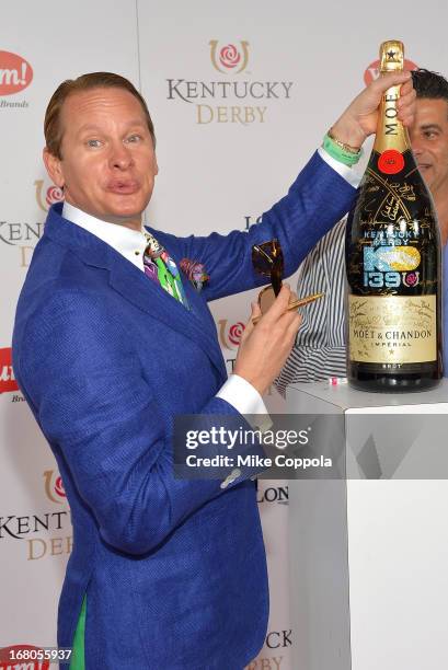 Carson Kressley signs the Moet & Chandon 6L for the Churchill Downs Foundation during the 139th Kentucky Derby at Churchill Downs on May 4, 2013 in...