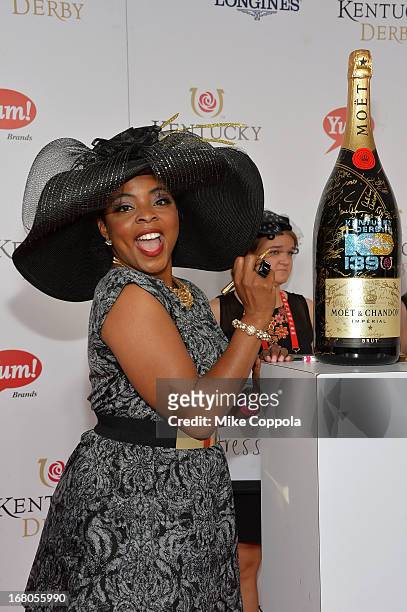 Actress Brely Evans signs the Moet & Chandon 6L for the Churchill Downs Foundation during the 139th Kentucky Derby at Churchill Downs on May 4, 2013...