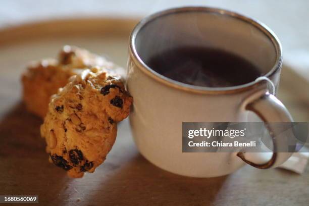 steaming cup - tea biscuits stock pictures, royalty-free photos & images