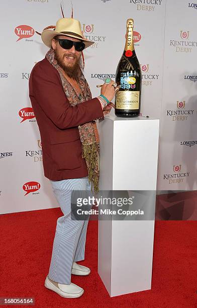 Nicholas David signs the Moet & Chandon 6L for the Churchill Downs Foundation during the 139th Kentucky Derby at Churchill Downs on May 4, 2013 in...