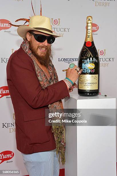 Nicholas David signs the Moet & Chandon 6L for the Churchill Downs Foundation during the 139th Kentucky Derby at Churchill Downs on May 4, 2013 in...