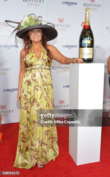 Jo Dee Messina signs the Moet & Chandon 6L for the Churchill Downs Foundation during the 139th Kentucky Derby at Churchill Downs on May 4, 2013 in...
