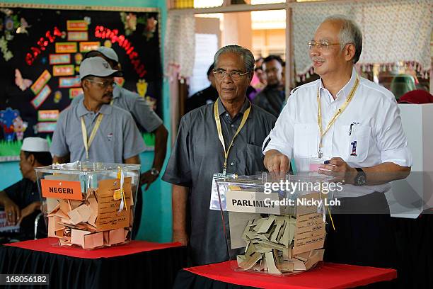 Malaysia's Prime Minister and Barisan Nasional chairman Najib Razak casts his vote at a polling station during election day on May 5, 2013 in Pekan,...