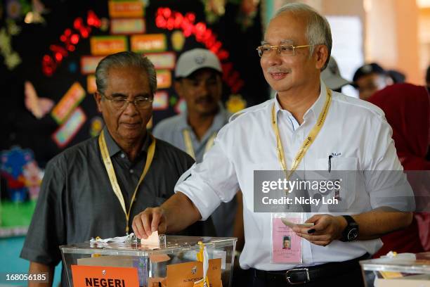 Malaysia's Prime Minister and Barisan Nasional chairman Najib Razak casts his vote at a polling station during election day on May 5, 2013 in Pekan,...