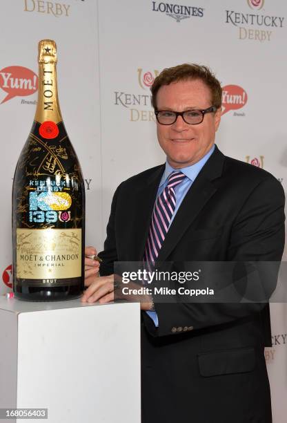 David Keith signs the Moet & Chandon 6L for the Churchill Downs Foundation during the 139th Kentucky Derby at Churchill Downs on May 4, 2013 in...