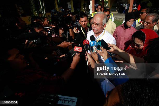 Malaysia's Prime Minister and Barisan Nasional chairman Najib Razak talks to the media during election day on May 5, 2013 in Pekan, Malaysia....