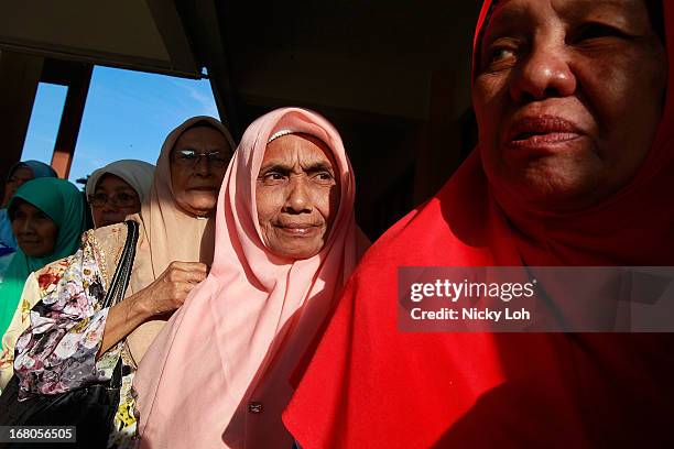 Voters line up at a polling station during election day on May 5, 2013 in Pekan, Malaysia. Millions of Malaysians casted their vote on Sunday in one...