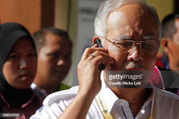 Malaysia's Prime Minister and Barisan Nasional chairman Najib Razak leaves after casting his vote a polling station during election day on May 5,...