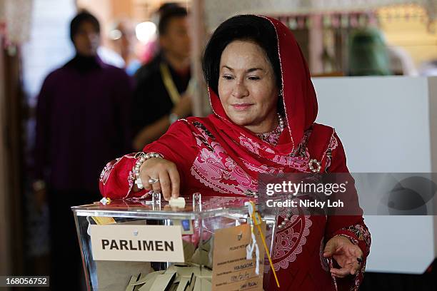 Rosamah Mansor, the wife of Malaysia's Prime Minister and Barisan Nasional chairman Najib Razak, casts her vote a polling station during election day...