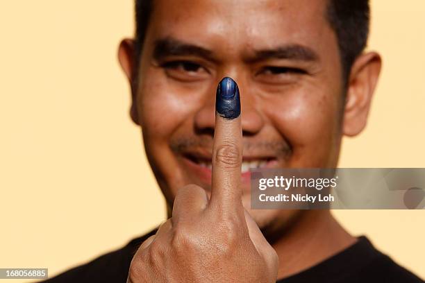 Voter poses with his inked finger at a polling station during election day on May 5, 2013 in Pekan, Malaysia. Millions of Malaysians casted their...