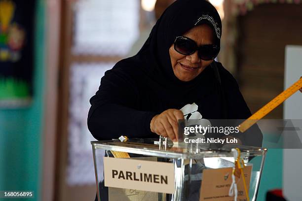 Woman casts her vote a polling station during election day on May 5, 2013 in Pekan, Malaysia. Millions of Malaysians casted their vote on Sunday in...