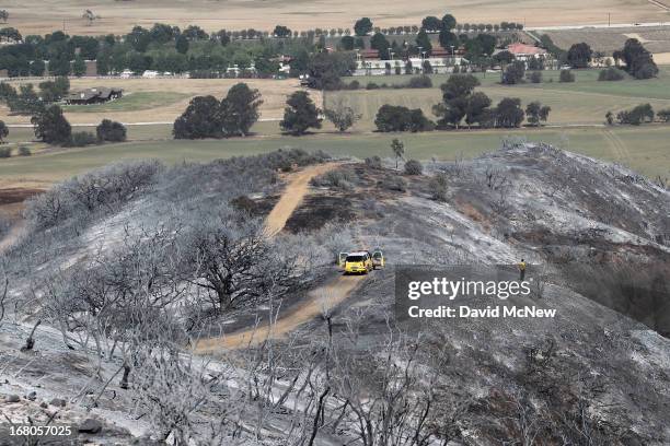 Firefighter surveys burned hills near Hidden Valley at the Springs fire on May 4, 2013 near Camarillo, California. Improving weather conditions are...