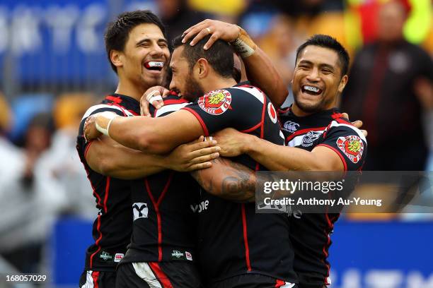 Feleti Mateo of the Warriors is mobbed by teammates Ben Henry and Jerome Ropati after his try during the round eight NRL match between the New...