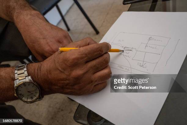 Veteran Palestinian teacher who gave the name Mahmoud diagrams the location in the Palestinian refugee camp of Ain al-Hilweh, in the parking lot of a...