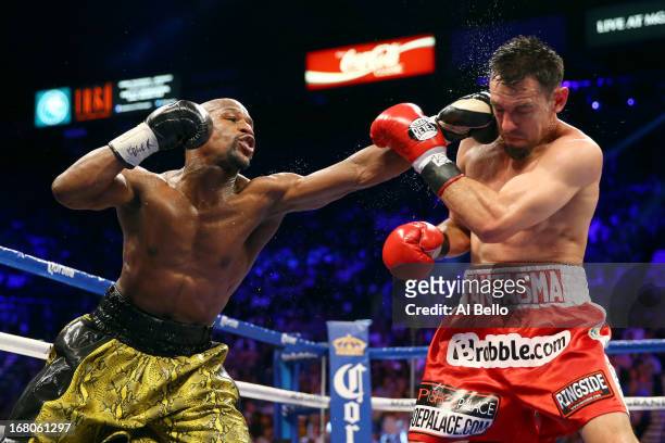 Floyd Mayweather Jr. Throws a left to the face of Robert Guerrero in their WBC welterweight title bout at the MGM Grand Garden Arena on May 4, 2013...
