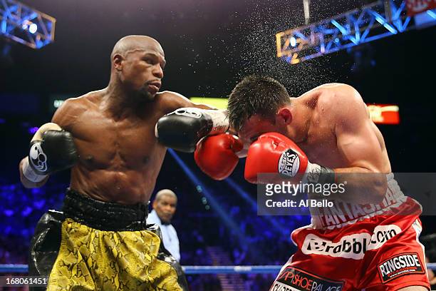 Floyd Mayweather Jr. Throws a left to the face of Robert Guerrero in their WBC welterweight title bout at the MGM Grand Garden Arena on May 4, 2013...