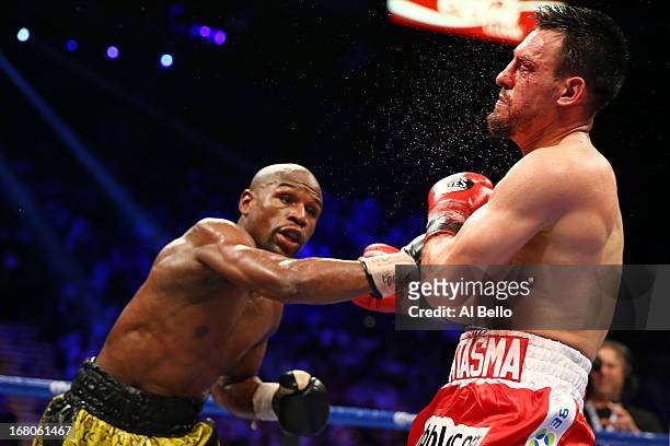 Floyd Mayweather Jr. Throws a right to the face of Robert Guerrero in their WBC welterweight title bout at the MGM Grand Garden Arena on May 4, 2013...