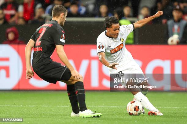 Josip Stanisic of Bayer 04 Leverkusen and Momodou Lamin Sonko of BK Haecken battle for the ball during the UEFA Europa League 2023/24 group stage...