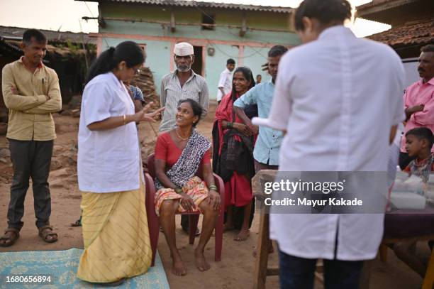doctor examining a woman during a part of rural health care camp - maharashtra stock pictures, royalty-free photos & images