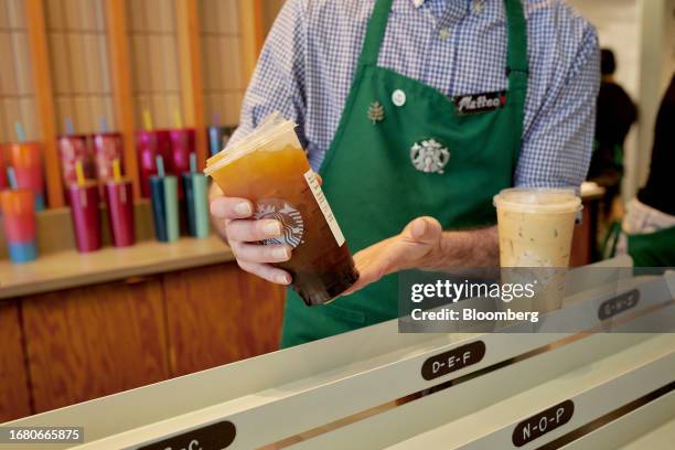 Barista places an iced coffee in the mobile pickup area at a Starbucks location in New York, US, on Thursday, Aug. 17, 2023. Starbucks Corp. Spending...