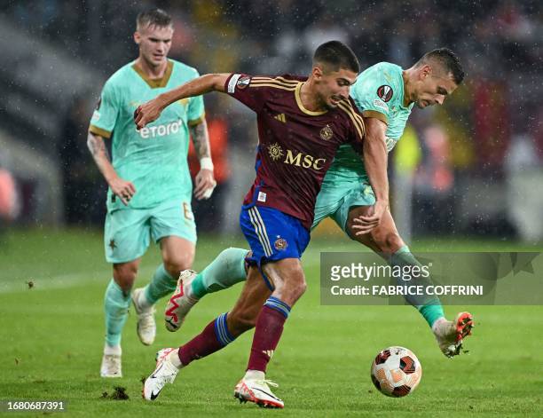 Servette's Swiss midfielder Alexis Antunes and SK Slavia Praha's Czech midfielder Tomas Holes fight for the ball during the UEFA Europa League Group...