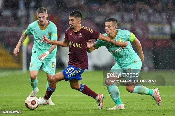 Servette's Swiss midfielder Alexis Antunes and SK Slavia Praha's Czech midfielder Tomas Holes fight for the ball during the UEFA Europa League Group...