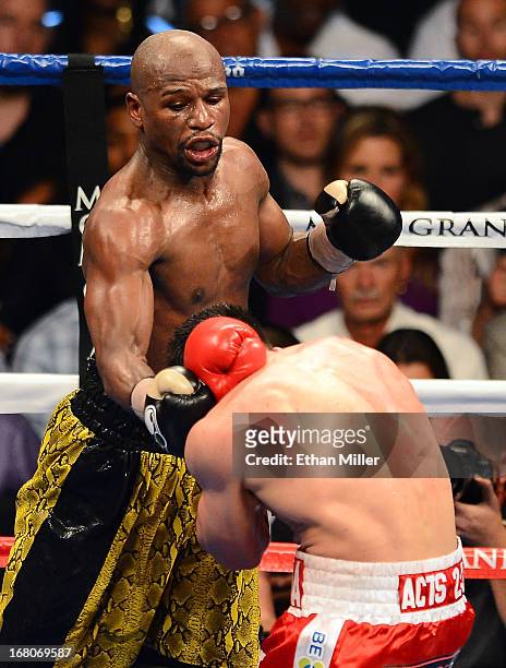 Floyd Mayweather Jr. Throws a right to the face of Robert Guerrero in their WBC welterweight title bout at the MGM Grand Garden Arena on May 4, 2013...