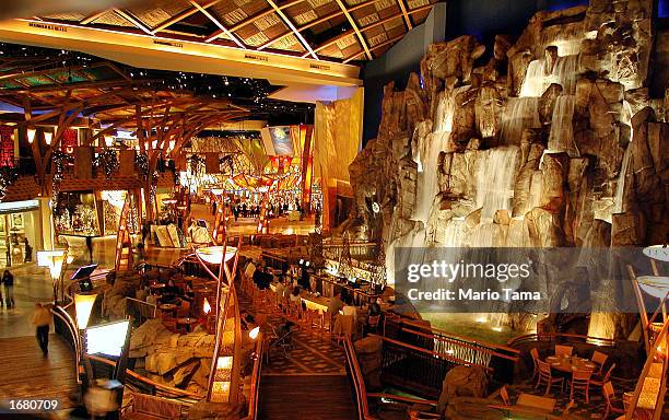 Visitors gather at a bar beneath a 55-foot indoor waterfall at Mohegan Sun casino November 20, 2002 in Uncasville, Connecticut. The casino is owned...